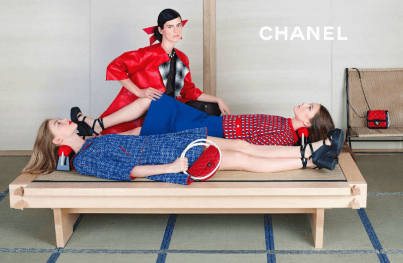 chanel ad from 2013 campaign featuring blue and red clothes, three models, and two takamakura geisha pillows