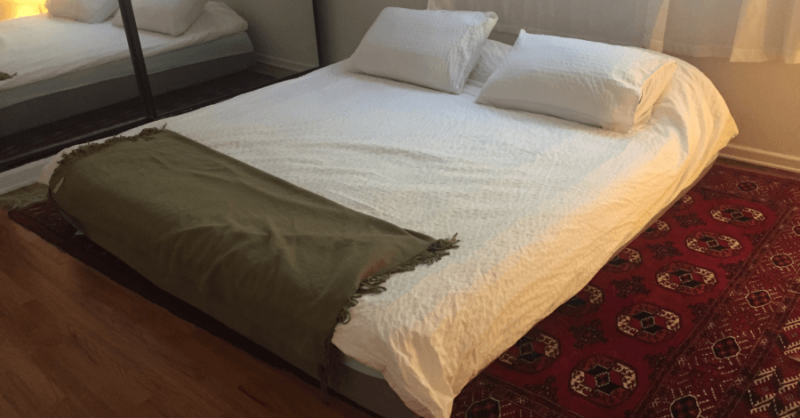 Nectar mattress with two pillows laid on carpeted floor