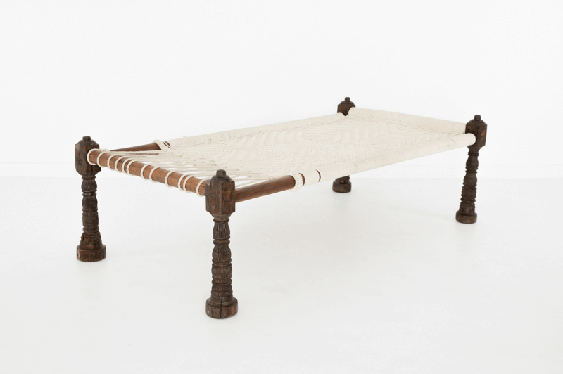 charpai rope bed with wooden frame on white background