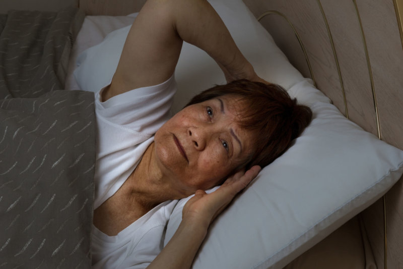 old woman awake in bed