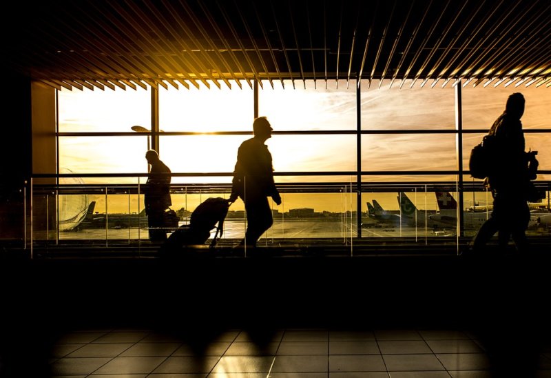 morning silhouette of man walking through airport